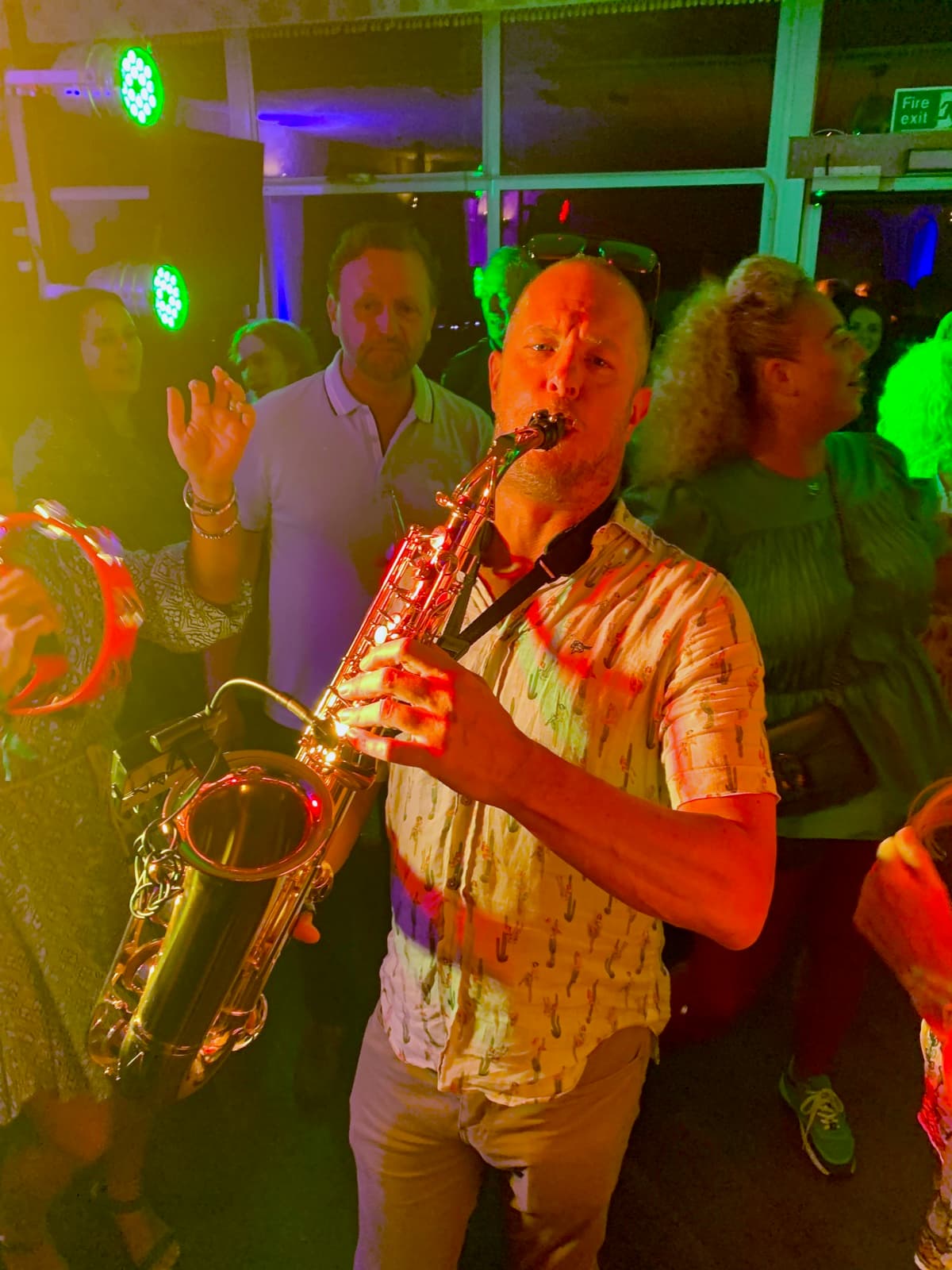 Mark Kirby playing the saxophone at a venue
